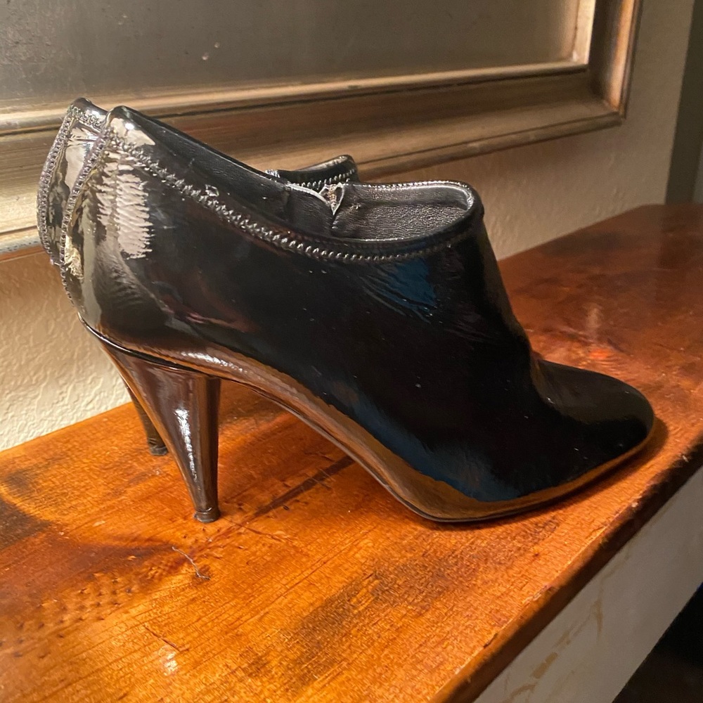 Black patent leather PRADA bootie heel.